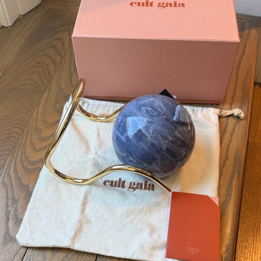 Cult Gaia Bag blue marbled resin orb with gold stand